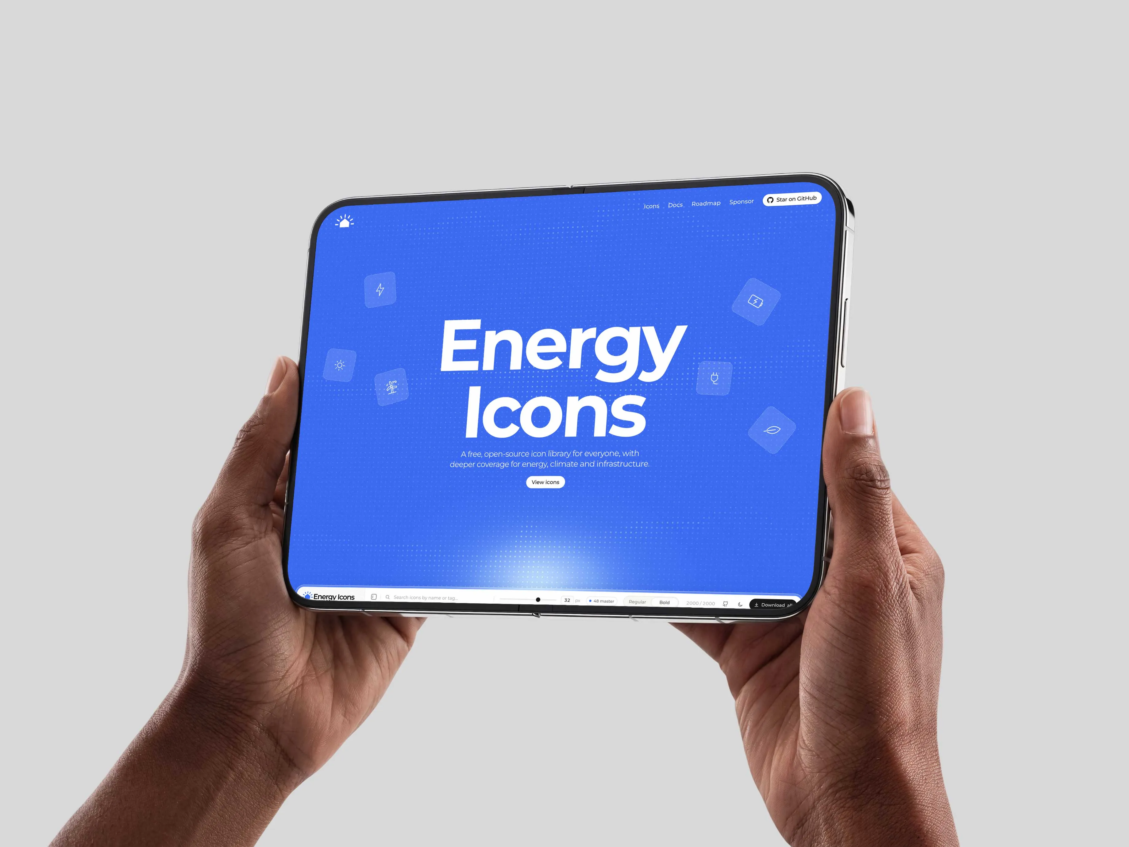 Hands holding a tablet showing the Energy Icons website
