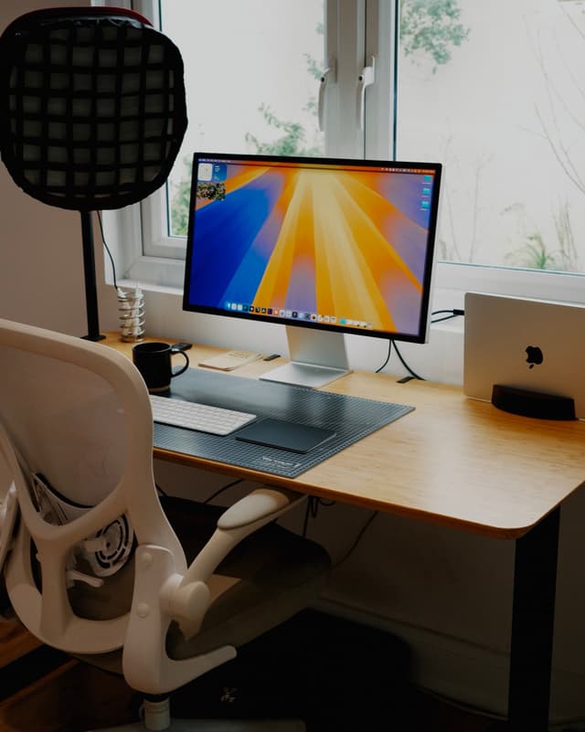 Sam's desk, with a Studio Display, MacBook, and Embody chair